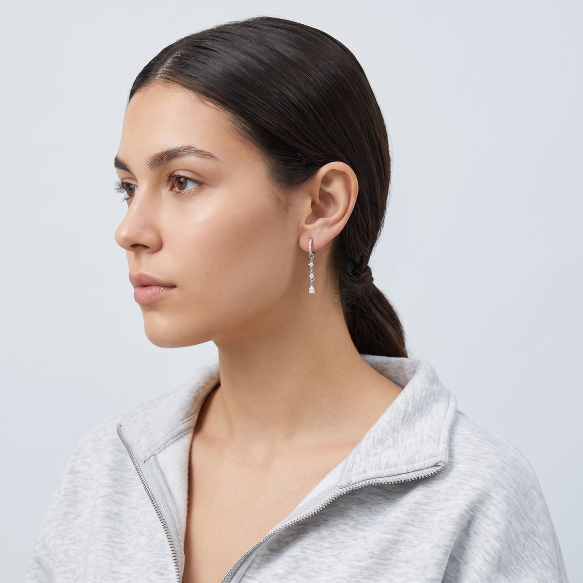 Model wearing the Lelice Héloïse Silver Drops in silver, slicked-back profile