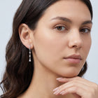 Model wearing the Lelice Héloïse Silver Drops in silver, hand at the chin