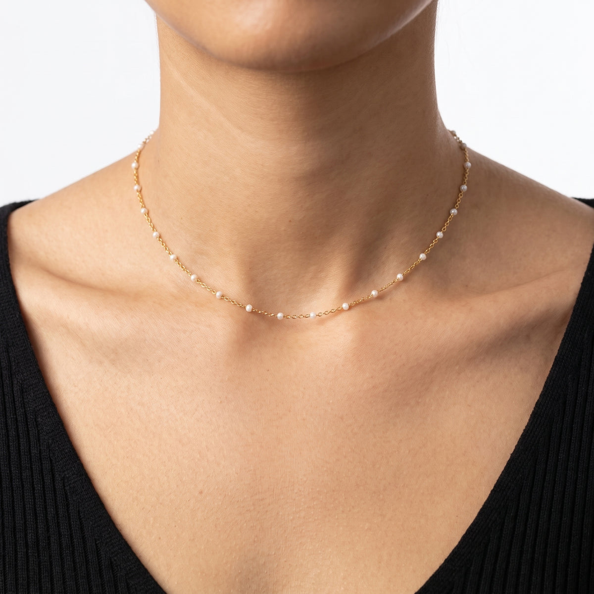 Close-up of the Lelice Ibiza Beaded Choker in gold at the collarbone