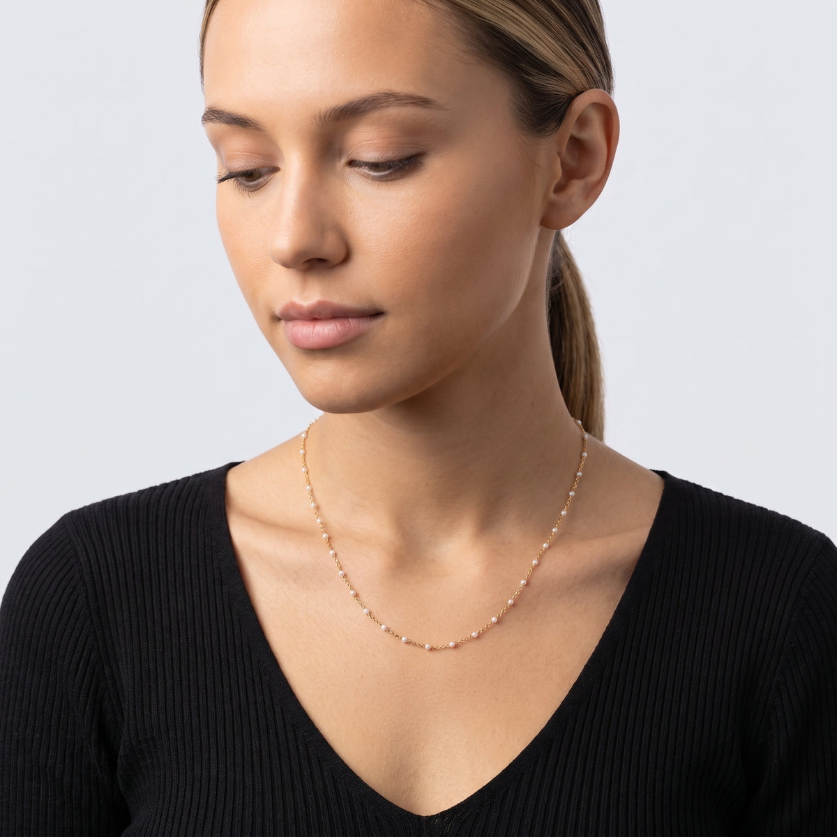 Woman looking down at the Ibiza Beaded Choker