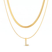 Lelice Initial Herringbone Necklace in gold on a white background