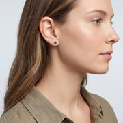 Model wearing the Lelice Jade Emerald Studs in gold, side profile portrait