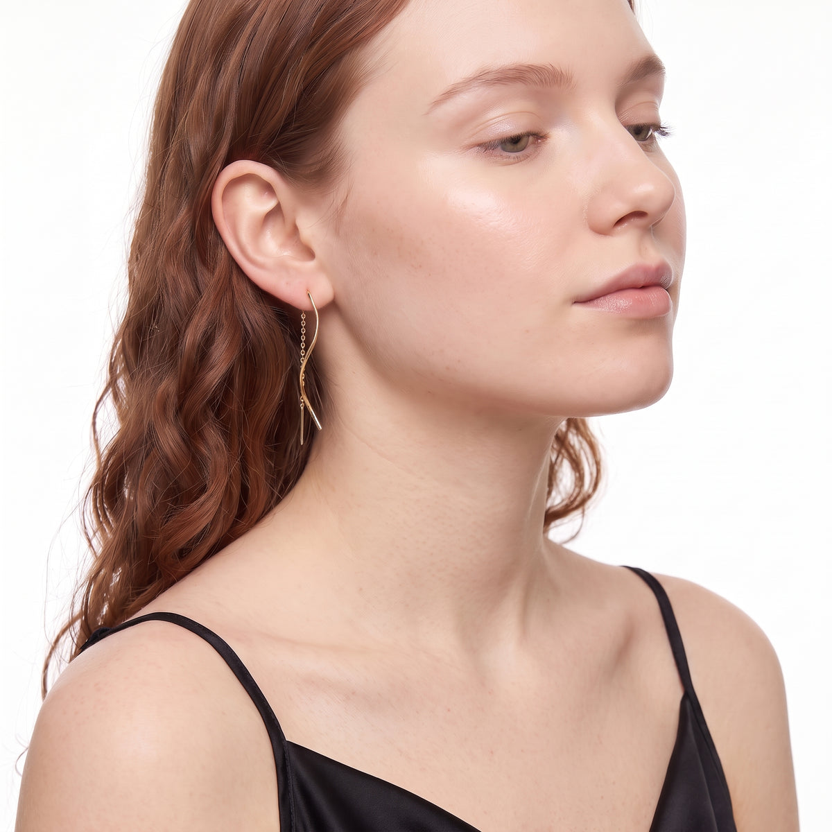 Woman with chin lifted wearing Jane gold threader earrings