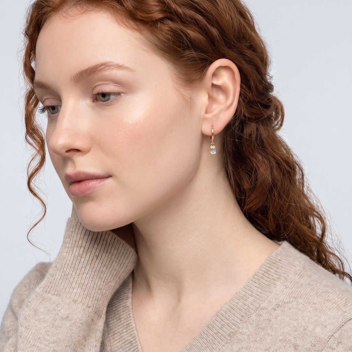 Model wearing the Lelice Justine Crystal Drops in gold, serene chin lift