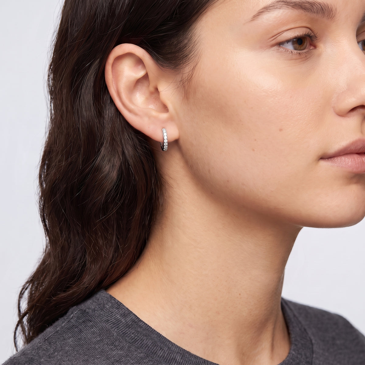 Model wearing the Lelice Kaia Hoop Earrings in silver, ear and jaw, slightly wider