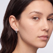 Model wearing the Lelice Kaia Hoop Earrings in silver, three-quarter face close-up