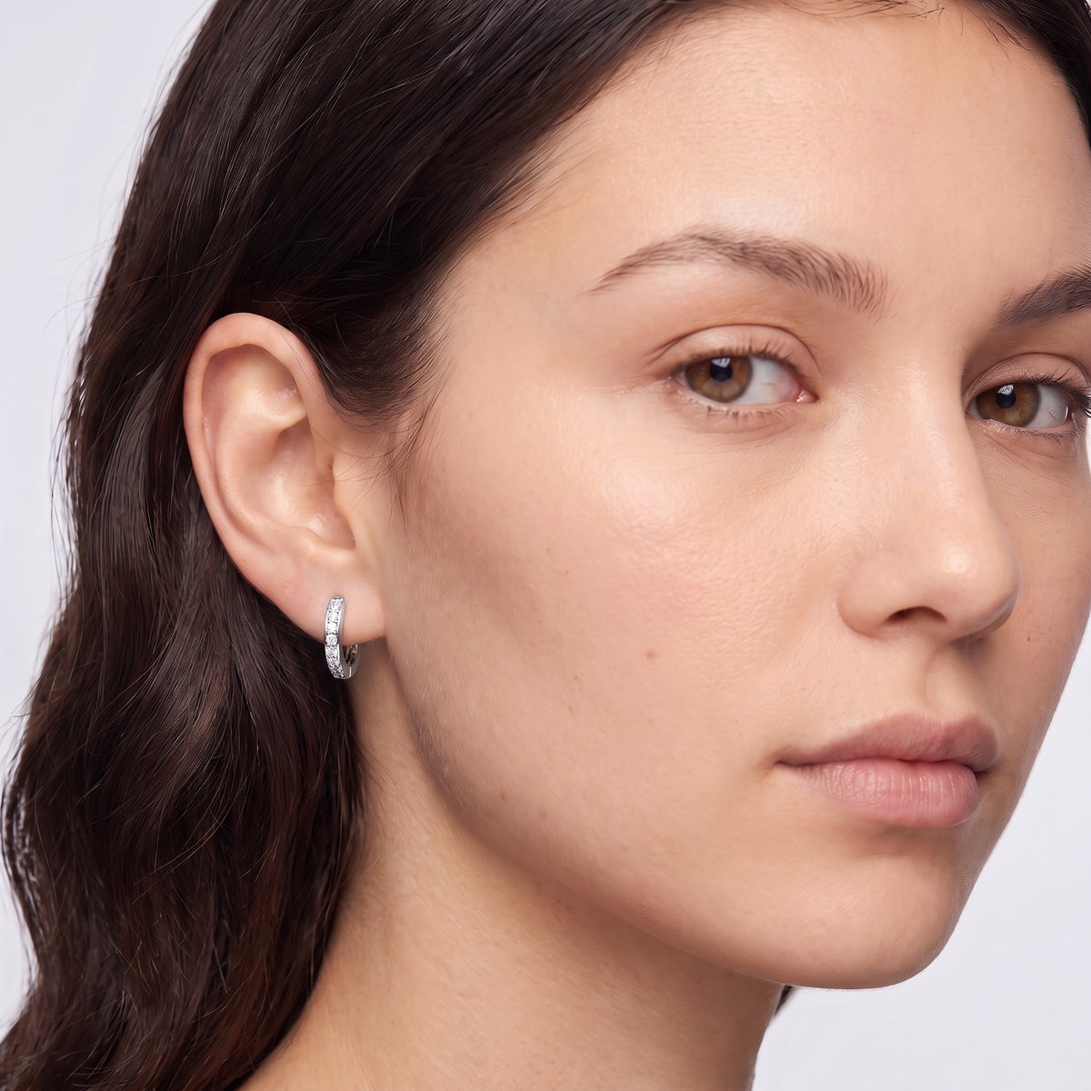 Model wearing the Lelice Kaia Hoop Earrings in silver, three-quarter face close-up