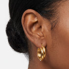 Close-up of the Lelice Kate Sleek Hoops in gold on the ear
