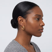 Model wearing the Lelice Kate Sleek Hoops in gold, slicked-back profile
