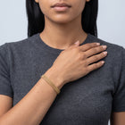 Model wearing the Lelice Léa Chain Bracelet in gold, hand across the chest