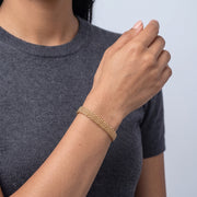 Model wearing the Lelice Léa Chain Bracelet in gold, forearm across the frame, hand relaxed