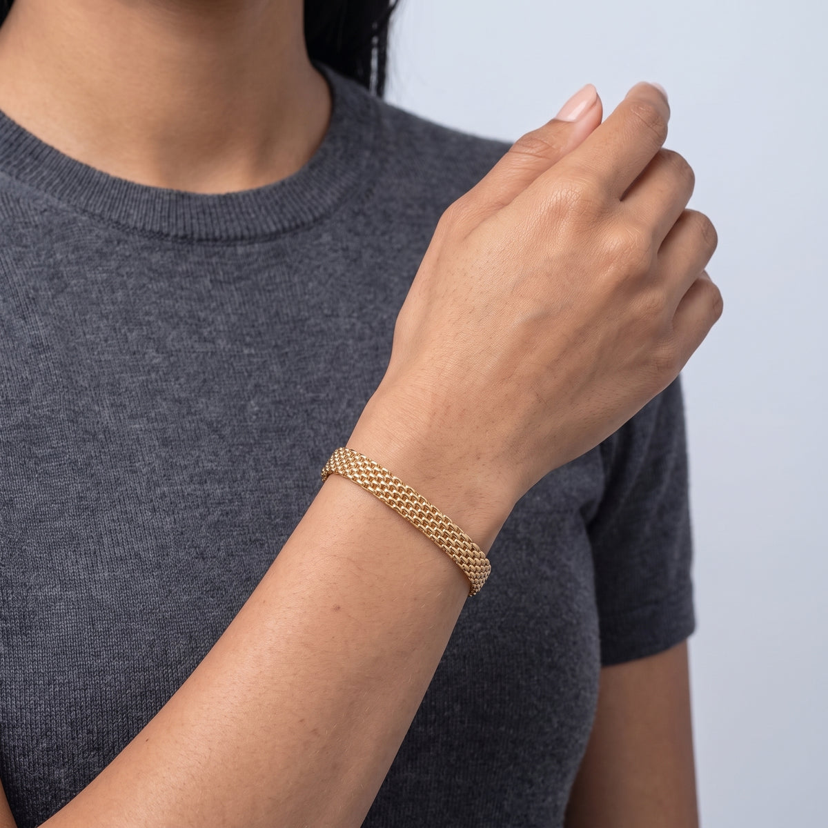 Model wearing the Lelice Léa Chain Bracelet in gold, forearm across the frame, hand relaxed