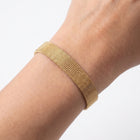 Close-up of the Lelice Celeste Sleek Bracelet in gold on the wrist