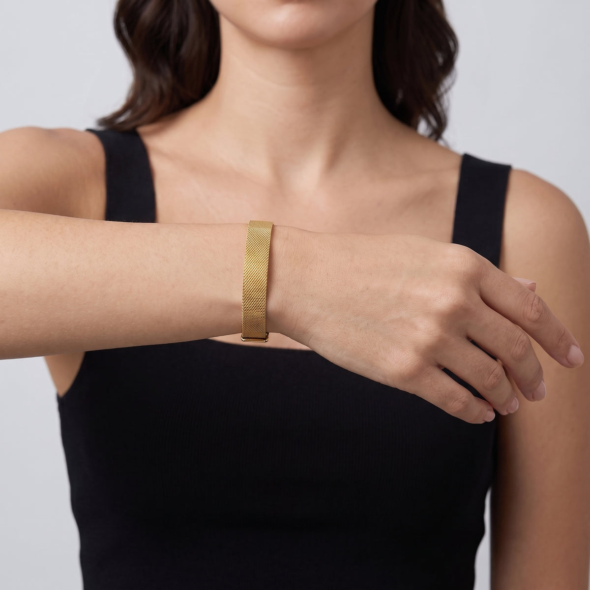 Model wearing the Lelice Celeste Sleek Bracelet in gold, forearm across the frame, hand relaxed