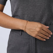 Model wearing the Lelice Classic Paperclip Chain in gold, hand resting at the waist