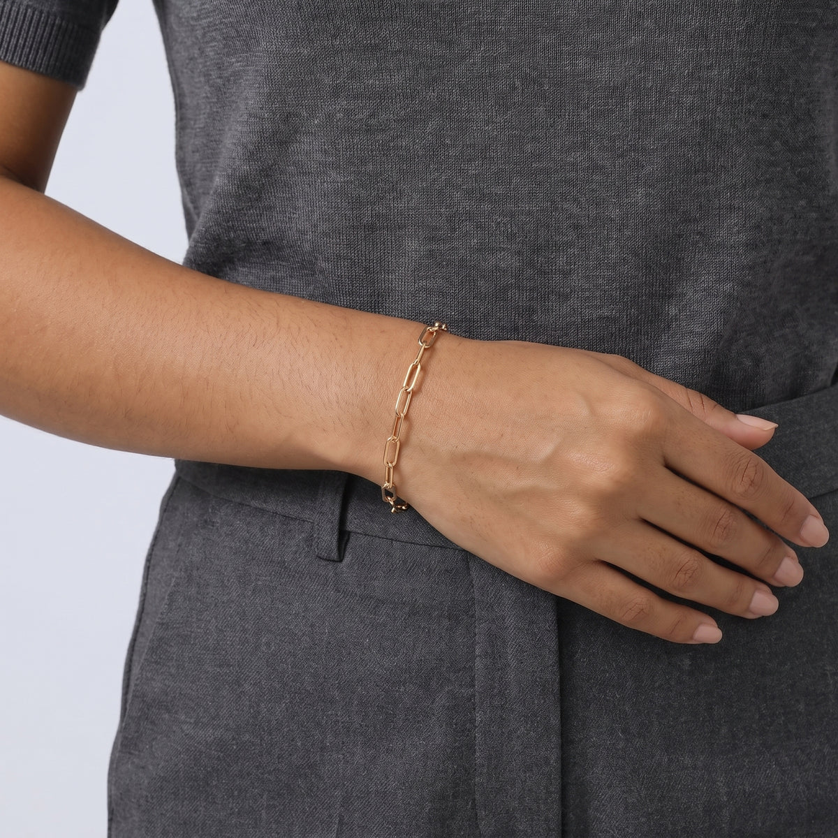 Model wearing the Lelice Classic Paperclip Chain in gold, hand resting at the waist