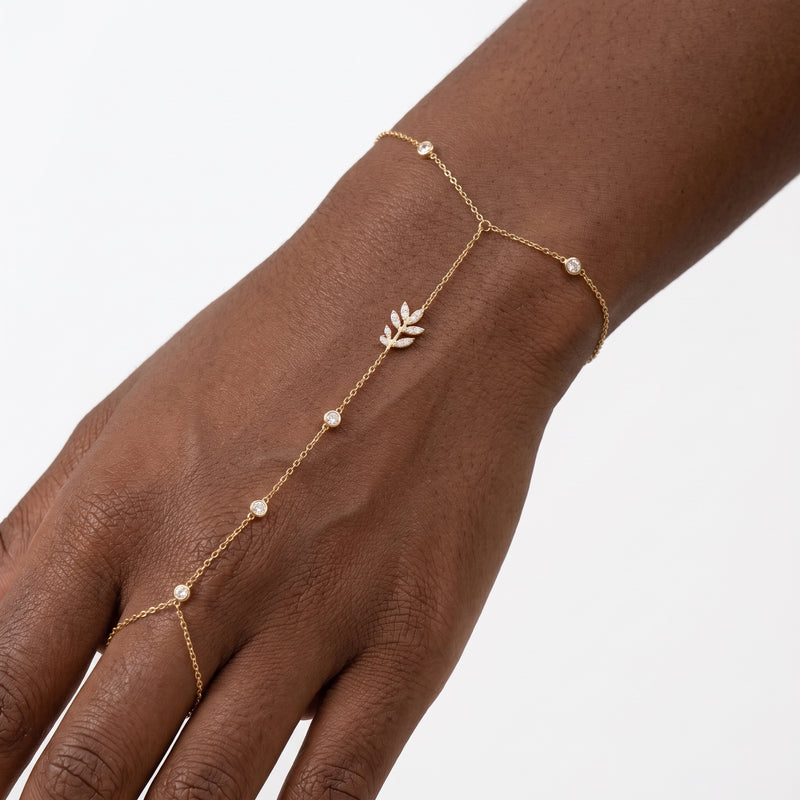 Close-up of the Lelice Crystal Vine Hand Chain in gold on the wrist and hand