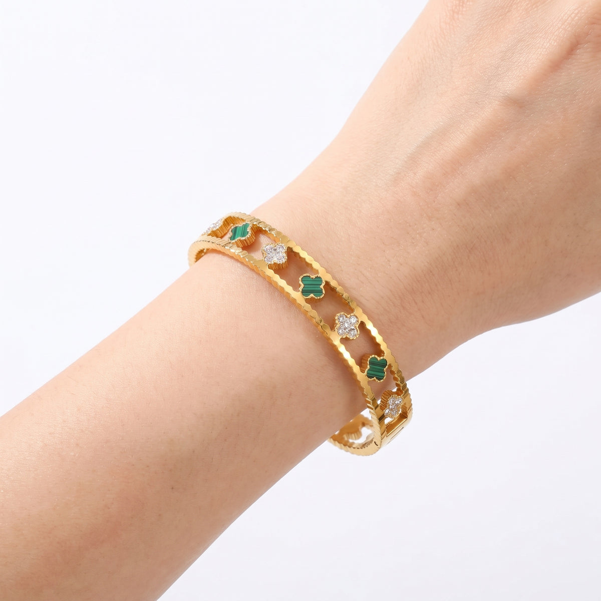 Close-up of the Lelice Dublin Quatrefoil Gold Bangle on the wrist