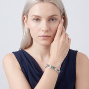 Model wearing the Lelice Dublin Quatrefoil Silver Bangle, hand at the face