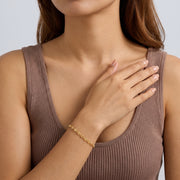 Model wearing the Lelice Heritage Mariner Bracelet in gold, hand across the chest