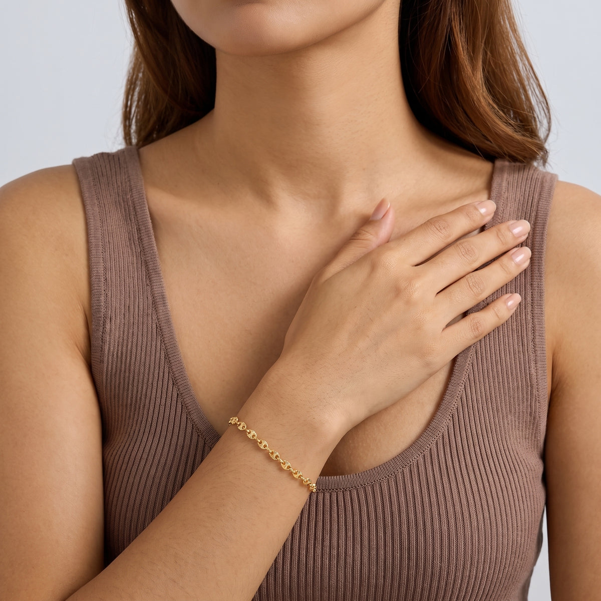 Model wearing the Lelice Heritage Mariner Bracelet in gold, hand across the chest