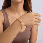 Model wearing the Lelice Heritage Mariner Bracelet in gold, forearm across the frame, hand relaxed