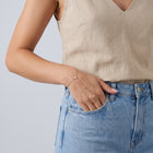Model wearing the Lelice Lyra Crystal Hand Chain in gold, hand in the jeans pocket