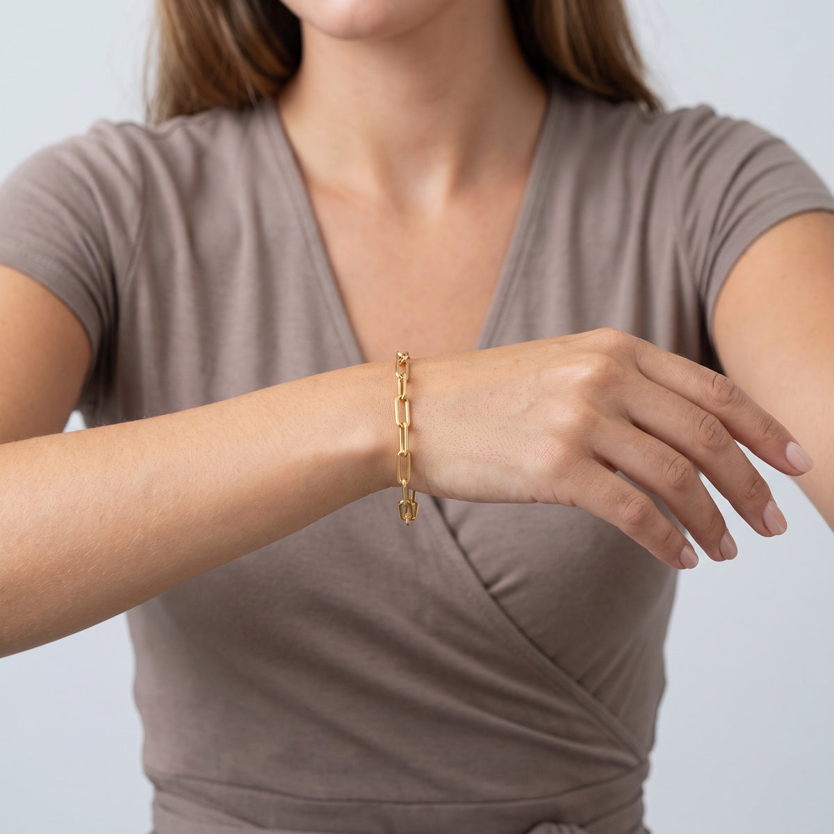 Model wearing the Lelice Margot Gold Paperclip Chain Link Bracelet, forearm across the frame, hand relaxed
