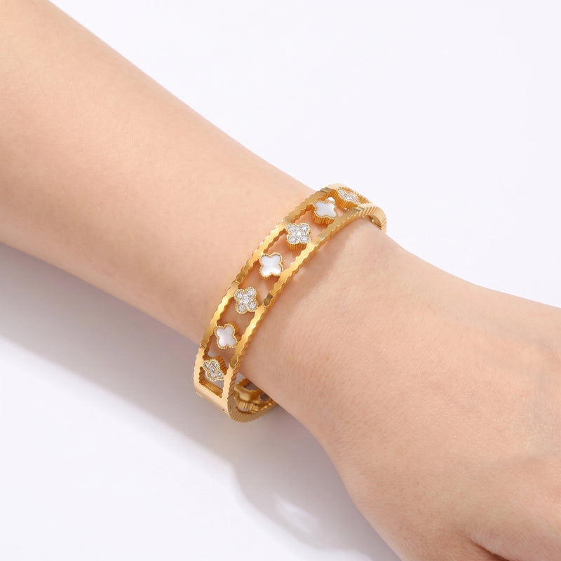 Close-up of the Lelice Miya Gold Clover Bangle on the wrist