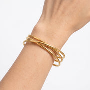 Close-up of the Lelice Rio Crossover Cuff in gold on the wrist