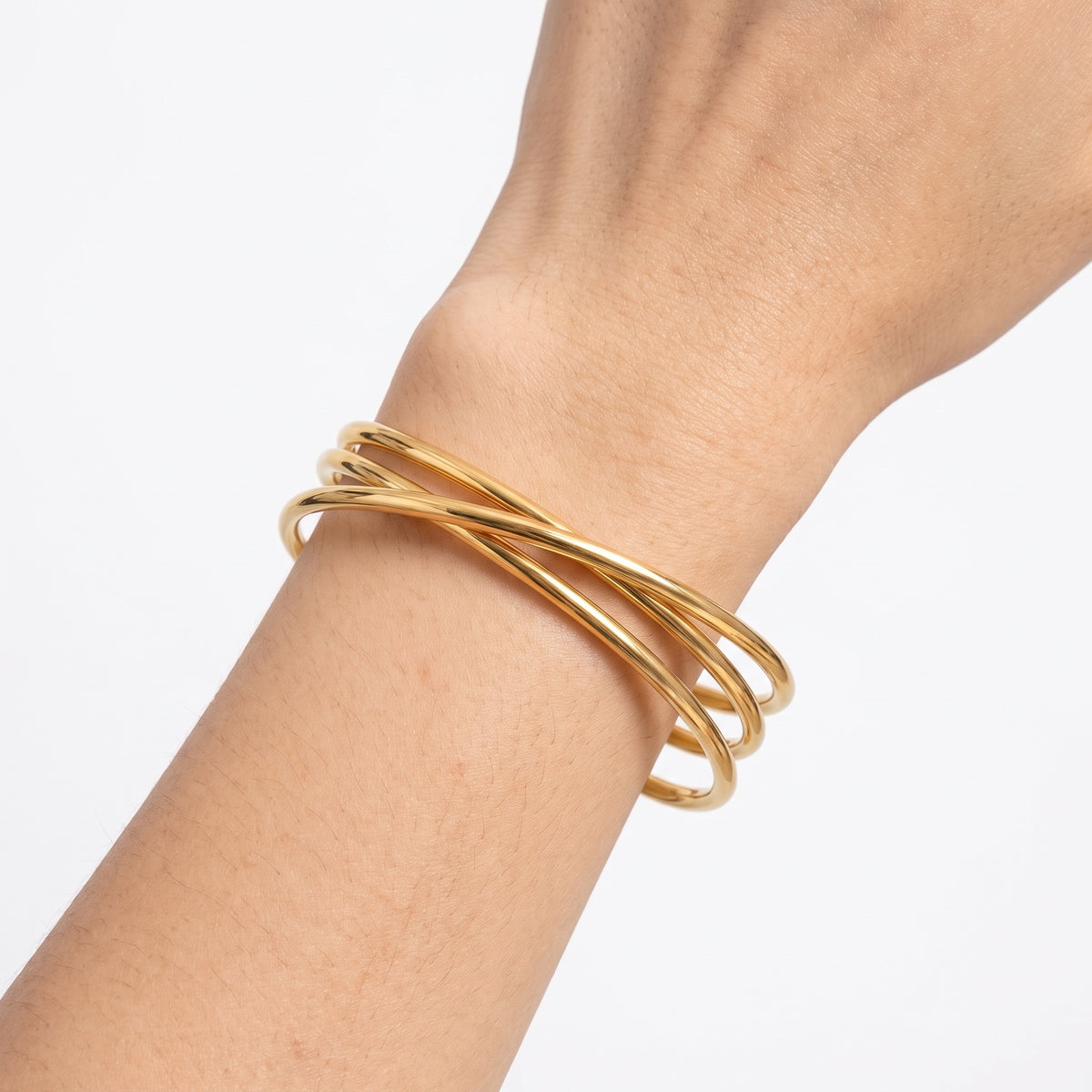 Close-up of the Lelice Rio Crossover Cuff in gold on the wrist