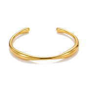 Lelice Sahara Wave Bangle in gold on a white background