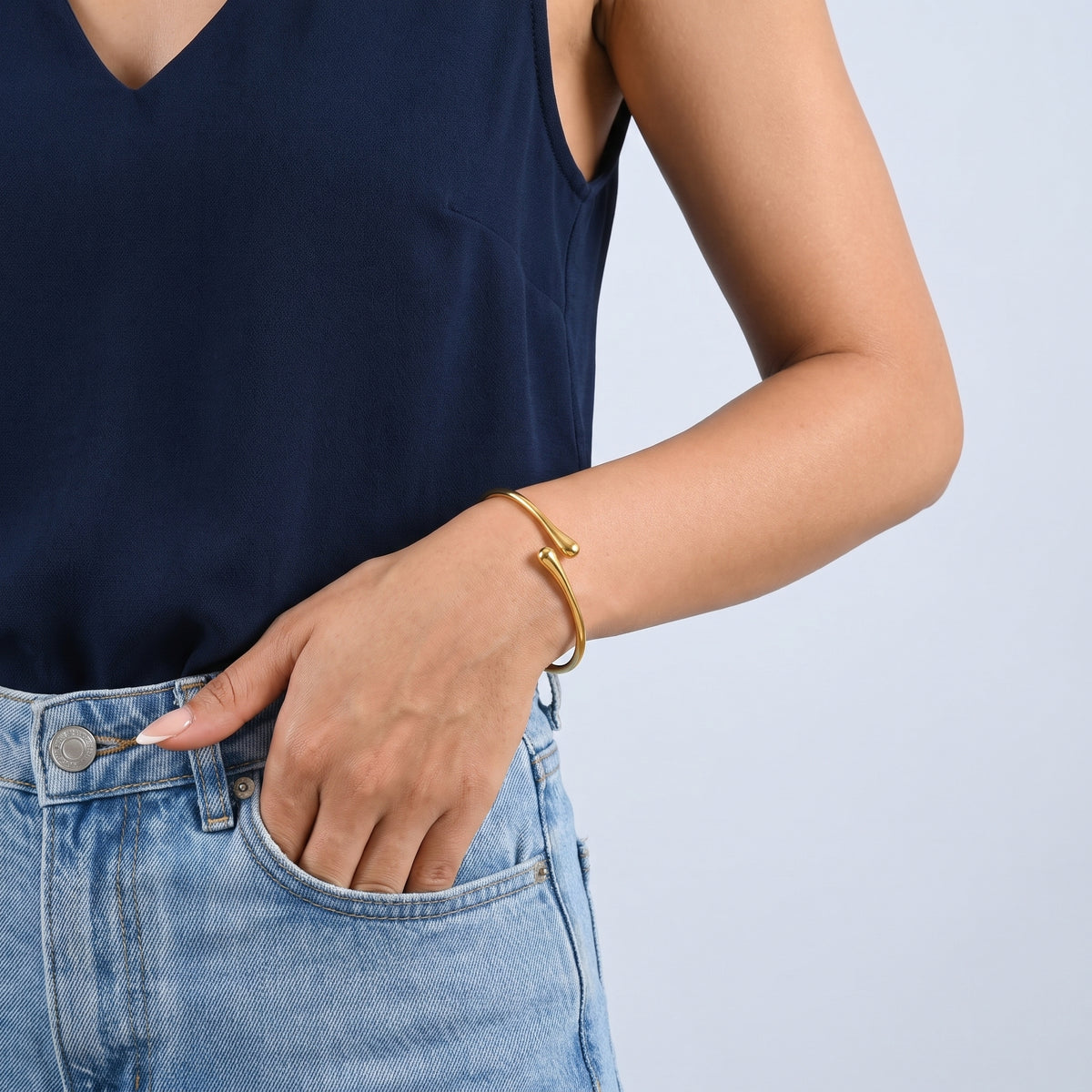 Model wearing the Lelice Sloane Gold Cuff, hand in the jeans pocket