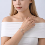 Model wearing the Lelice Sloane Silver Cuff, hand at the collar