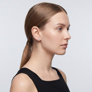 Model wearing the Lelice Léonie Silver Studs, slicked-back profile