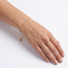 Wrist wearing Lelice gold crystal hand chain bracelet Lila