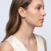 Model wearing the Lelice Lily Crystal Studs in gold, side profile portrait