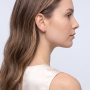 Model wearing the Lelice Lily Crystal Studs in gold, three-quarter back view
