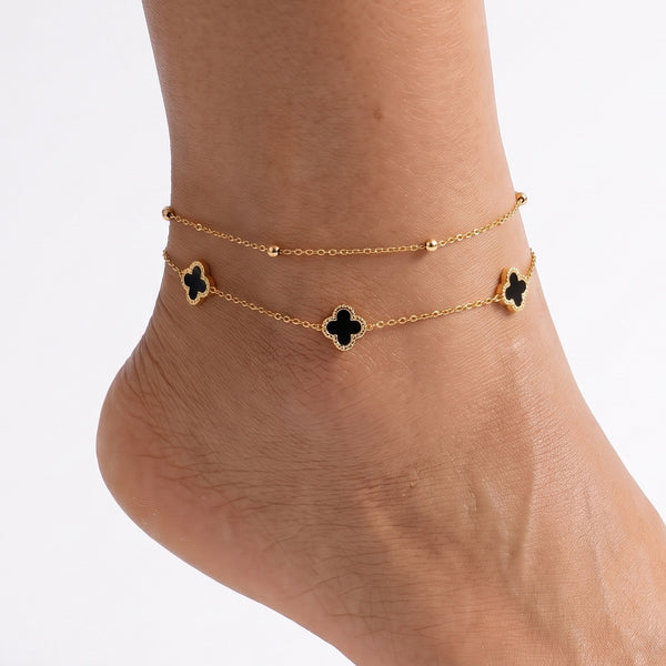 Ankle wearing Lelice gold black clover layered anklet Lise