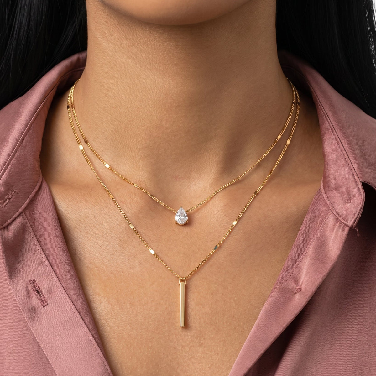 Close-up of the Lelice Livia Layered Necklace Set in gold at the collarbone