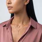 Three-quarter profile of a woman wearing the Livia Layered Necklace Set