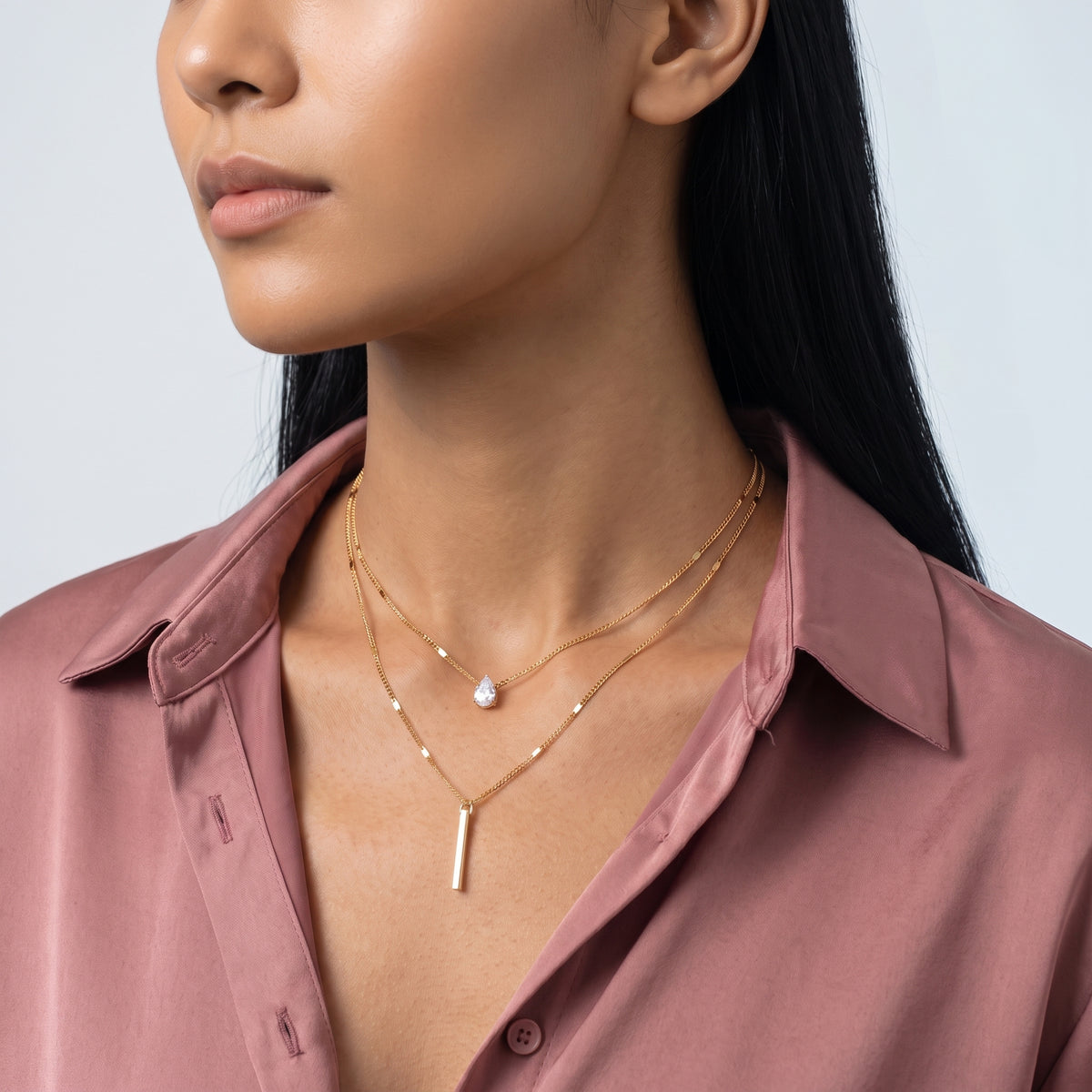 Three-quarter profile of a woman wearing the Livia Layered Necklace Set