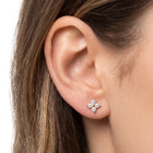 Close-up of ear wearing Lelice gold crystal flower stud earrings Lola
