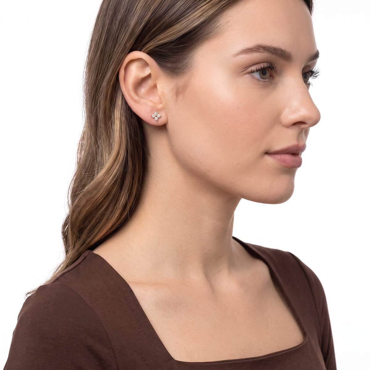 Side profile of woman wearing Lola gold flower studs