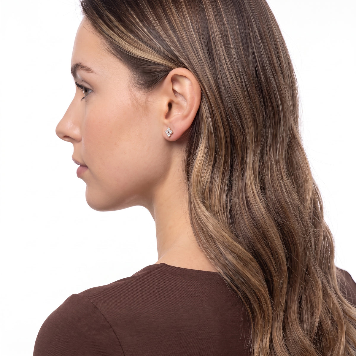 Three-quarter back view of woman wearing Lola gold flower studs