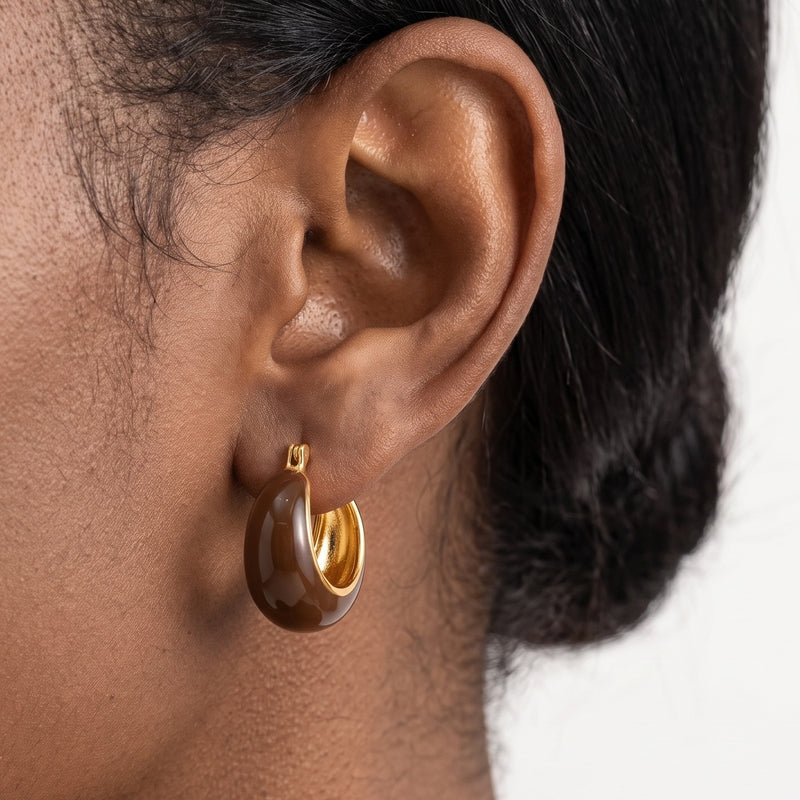 Close-up of the Lelice Lottie Espresso Chunky Hoops in gold on the ear