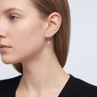 Model wearing the Lelice Lou Clover Earrings in gold, ear and jaw, slightly wider