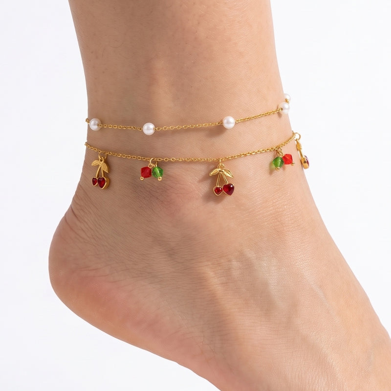 Close-up of the Lelice Louise Cherry Anklet in gold on a woman's ankle