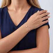 Model wearing the Lelice Louise Clover Bracelet in silver, wrist resting across the body