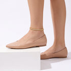 Side profile of a foot on a white block wearing the Lumière Woven Anklet